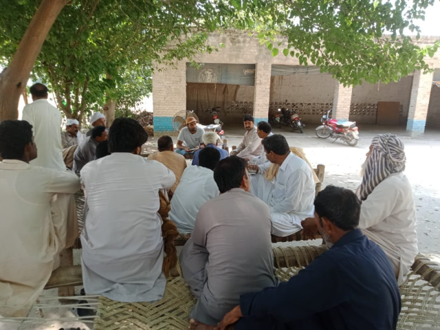 Villagers gather around.